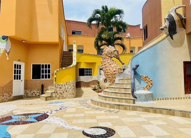 Hotel Katarma exterior with fish sculptures on staircase